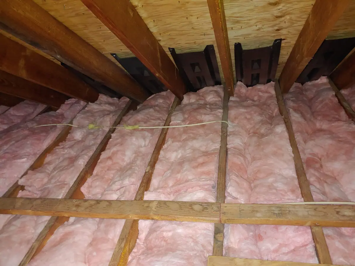 Attic insulation and rafter ventilation baffles in a Rochester home