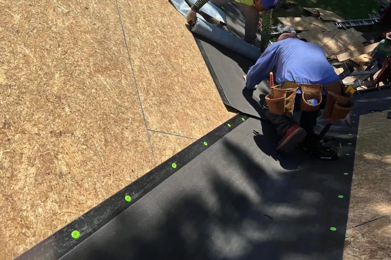 Tall Pines crew installing protective roof underlayment
