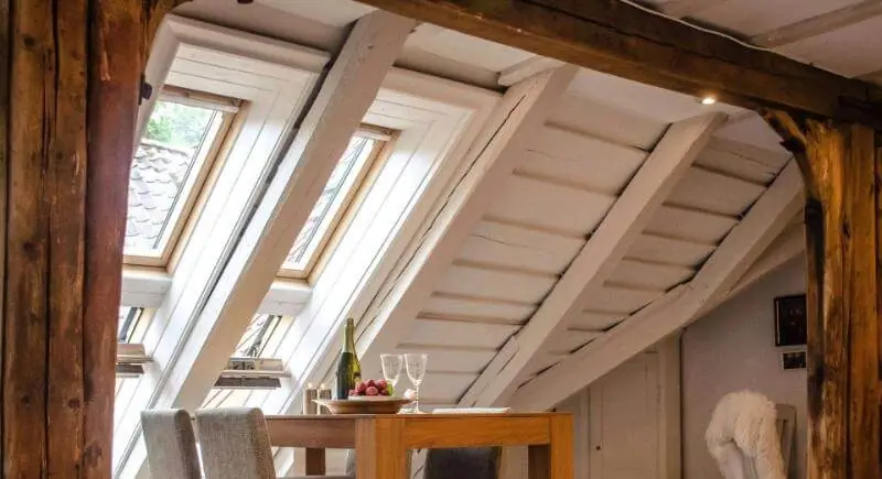 Interior skylights bringing daylight into a vaulted attic ceiling
